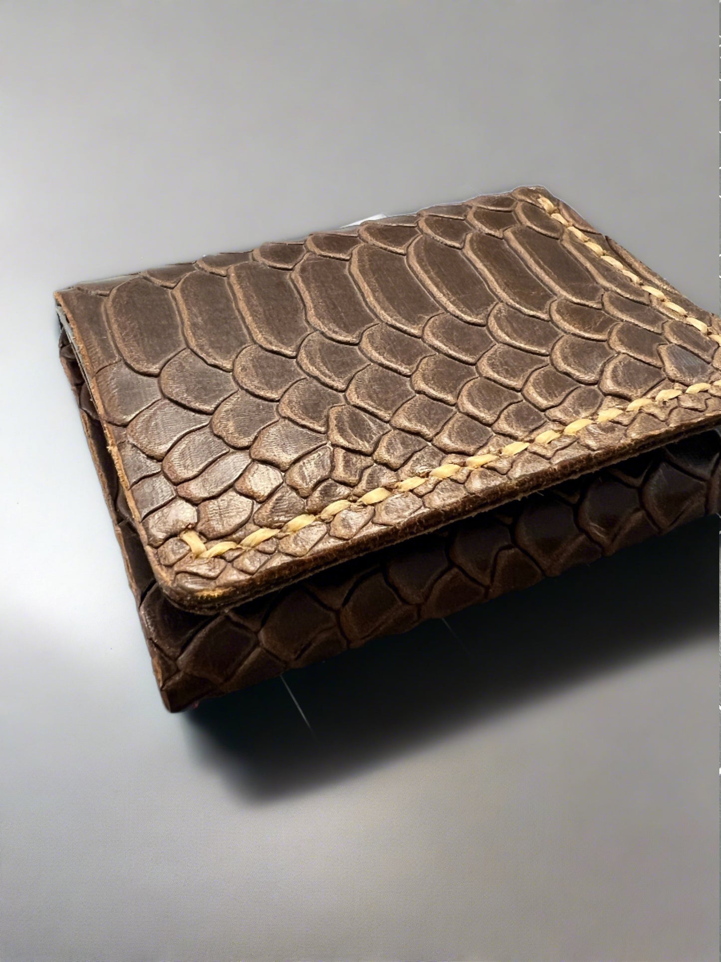 Brown snake embossed leather trifold wallet.