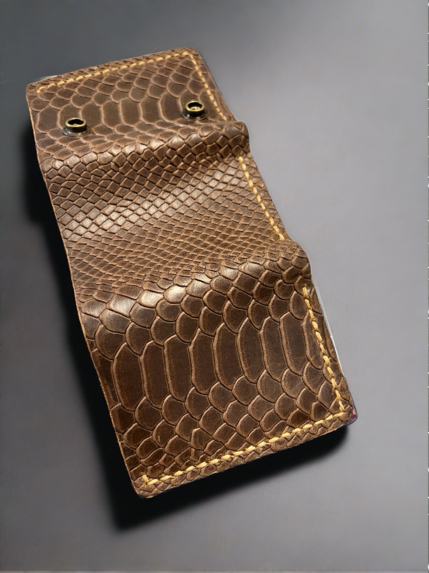 Brown snake embossed leather trifold wallet.