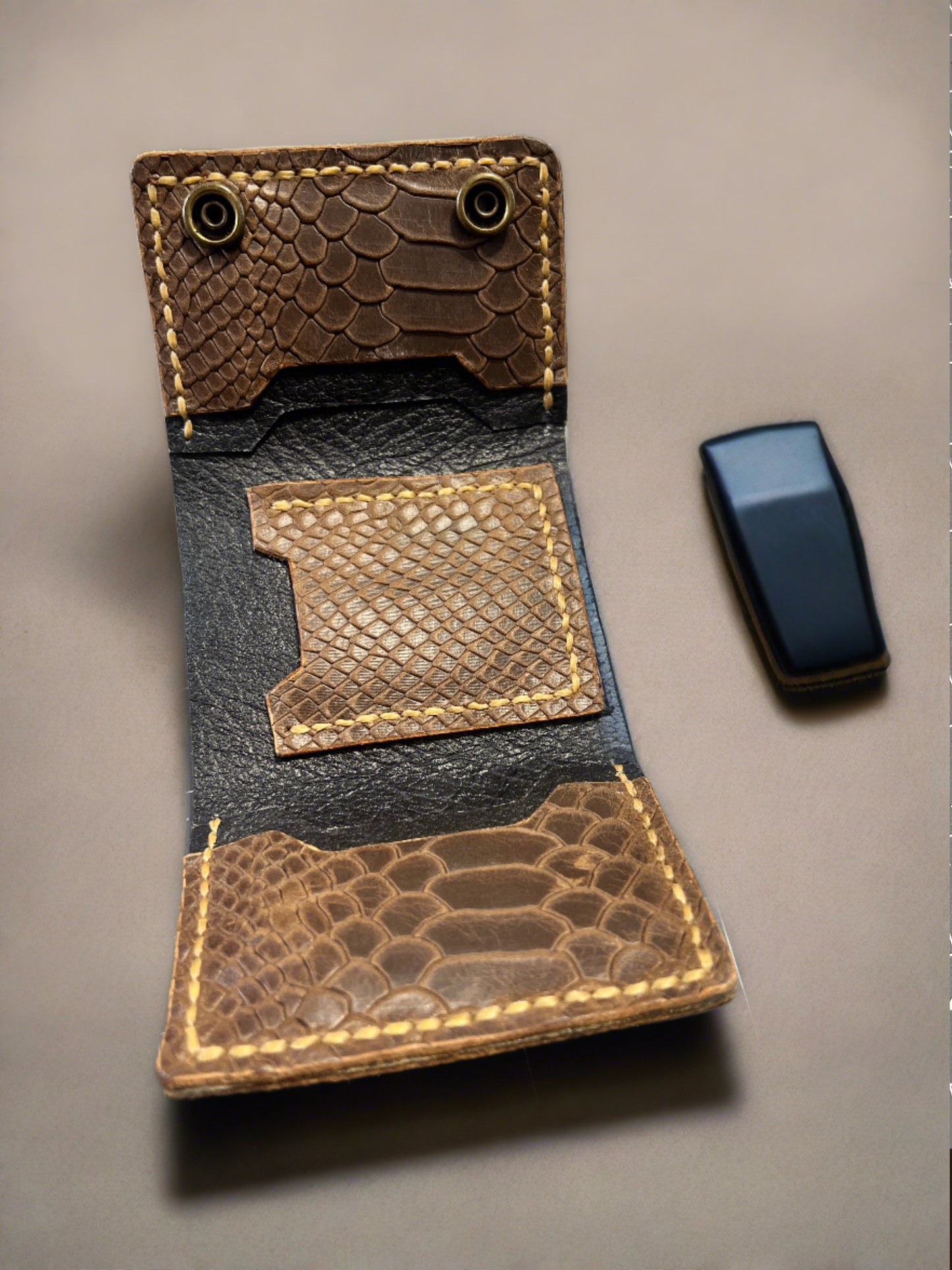 Brown snake embossed leather trifold wallet.
